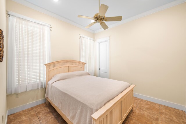 bedroom with crown molding, multiple windows, and ceiling fan