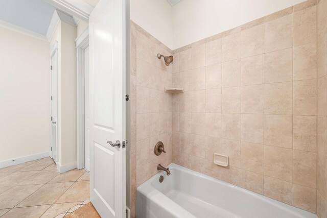 bathroom with tile patterned flooring, crown molding, and tiled shower / bath combo