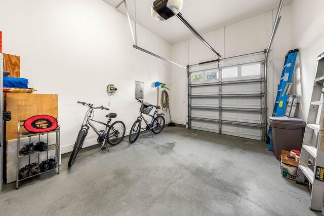 garage featuring electric panel and a garage door opener