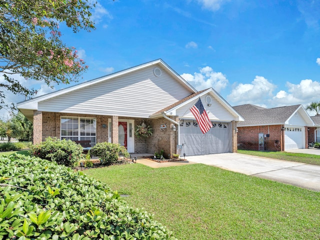 view of front facade with a garage, brick siding, concrete driveway, and a front yard