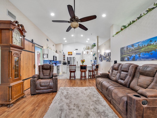 living room with recessed lighting, visible vents, a barn door, a ceiling fan, and light wood-type flooring