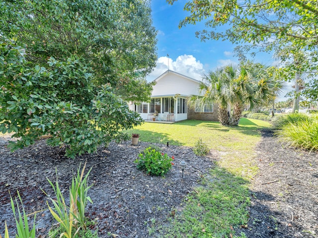 view of yard featuring a sunroom