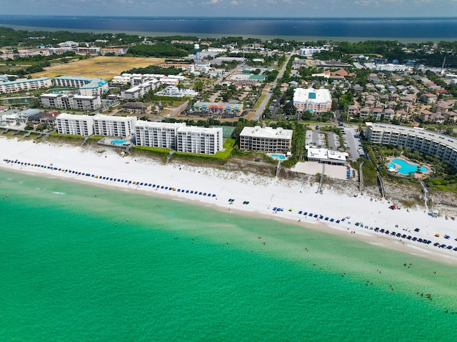 birds eye view of property with a water view and a beach view