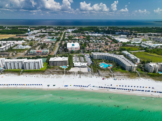 aerial view with a water view and a beach view