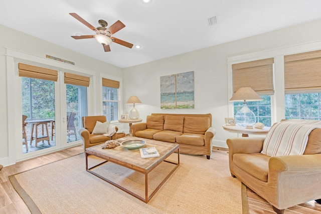 living room featuring ceiling fan and light wood-type flooring