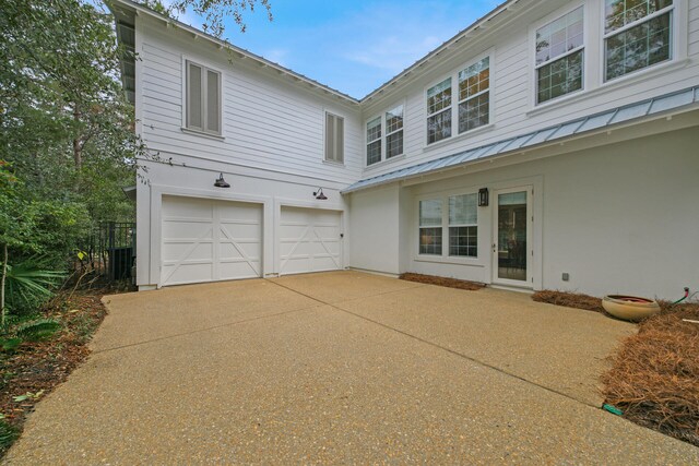 back of house with a garage