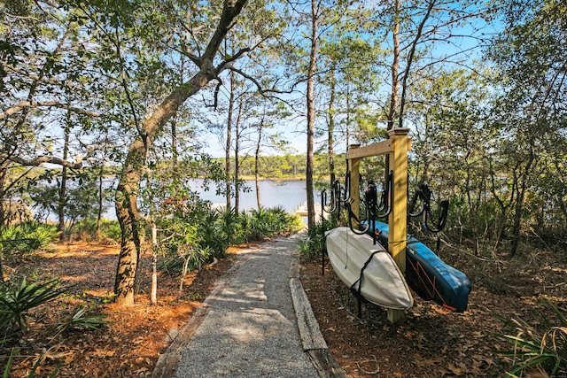 surrounding community featuring a water view and a playground