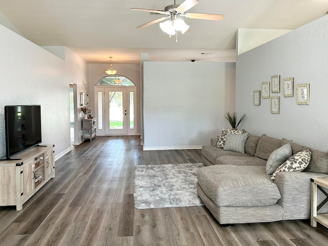 living room featuring ceiling fan and dark wood-type flooring