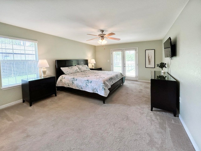 carpeted bedroom featuring ceiling fan, french doors, and access to exterior