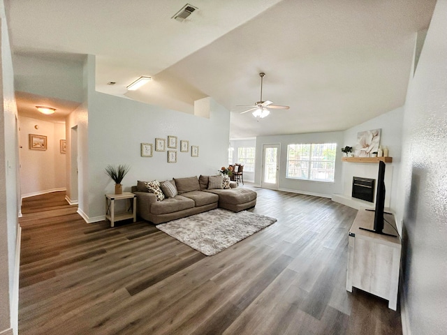 living room with ceiling fan, dark wood-type flooring, and lofted ceiling