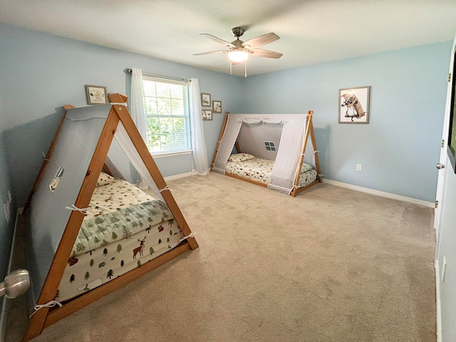 bedroom featuring ceiling fan and light carpet