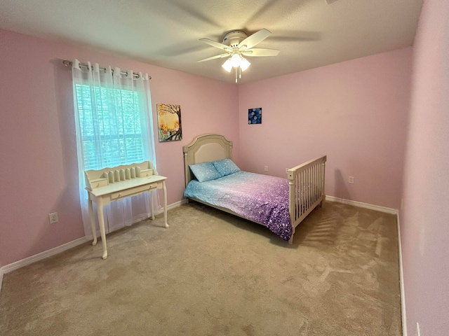 bedroom featuring ceiling fan and carpet