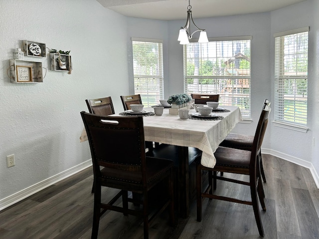 dining room featuring dark wood-type flooring and a notable chandelier