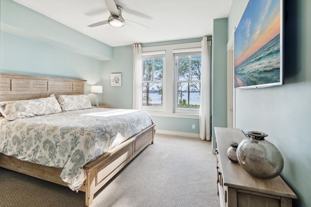 bedroom with ceiling fan and light colored carpet