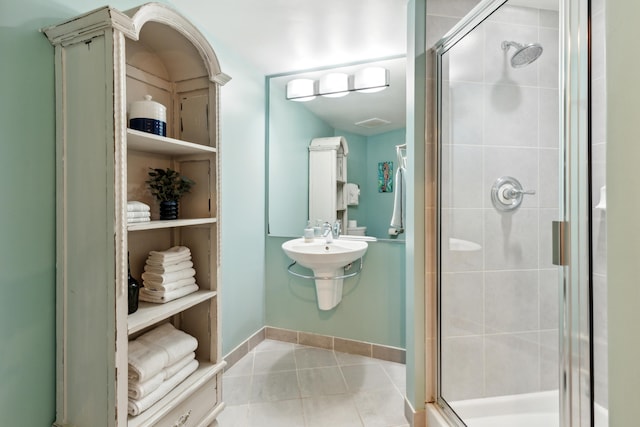 bathroom with tile patterned flooring and an enclosed shower