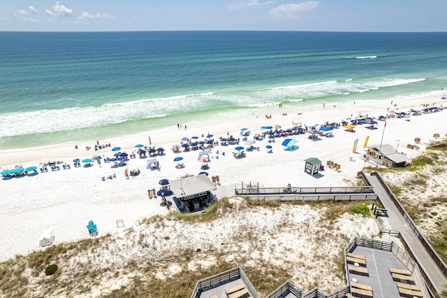 birds eye view of property featuring a beach view and a water view