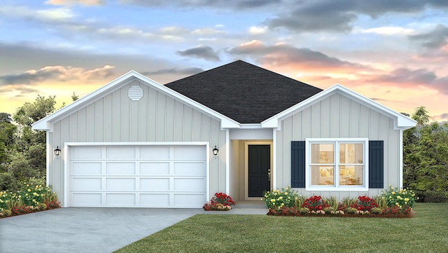 view of front of home featuring a lawn and a garage