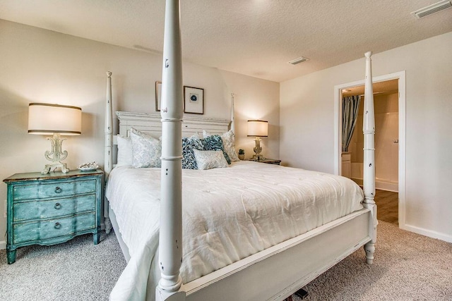 bedroom with baseboards, a textured ceiling, visible vents, and carpet flooring