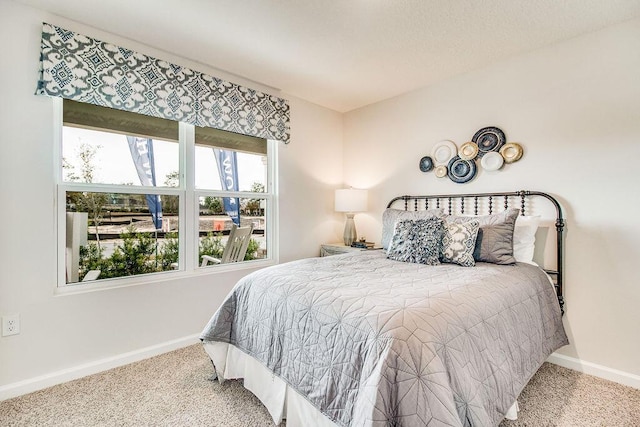 carpeted bedroom featuring baseboards