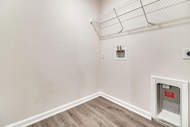 laundry room with washer hookup, hookup for an electric dryer, wood finished floors, laundry area, and baseboards