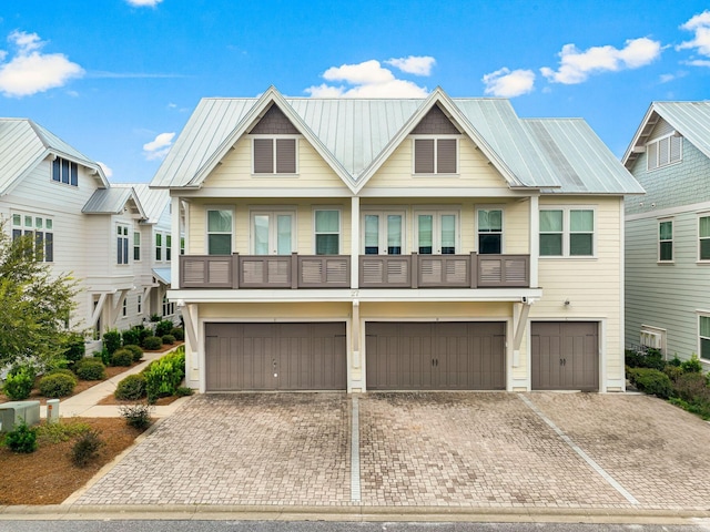 view of front of home with metal roof, decorative driveway, and an attached garage