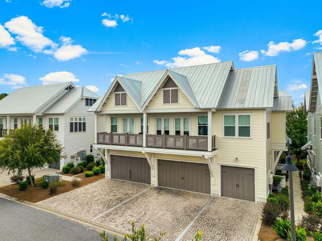 multi unit property featuring a garage and a balcony