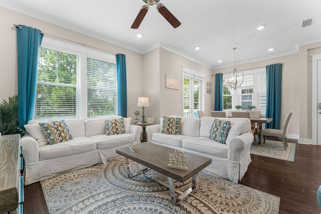 living area featuring a wealth of natural light, visible vents, ornamental molding, and wood finished floors