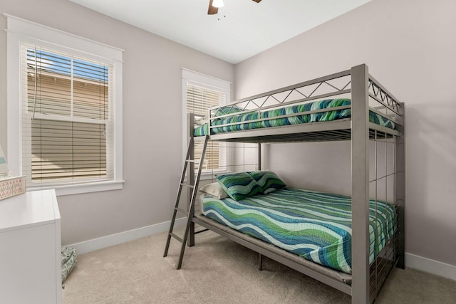 carpeted bedroom featuring ceiling fan and baseboards