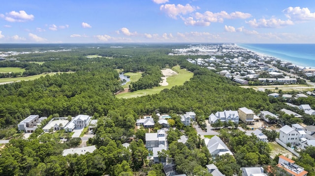 bird's eye view with a forest view, view of golf course, a residential view, and a water view