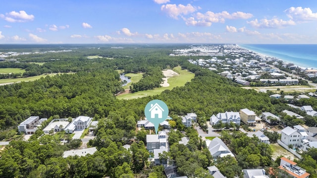 birds eye view of property with golf course view, a forest view, a residential view, and a water view