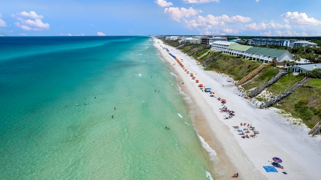 birds eye view of property featuring a beach view and a water view