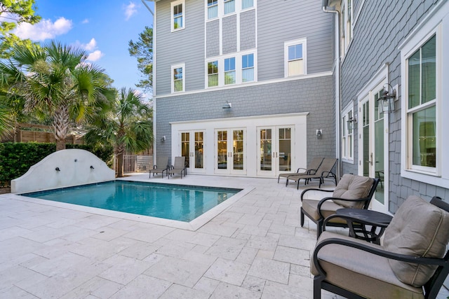 view of pool with a patio area and french doors