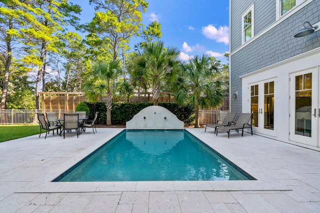 view of pool with a patio area and french doors