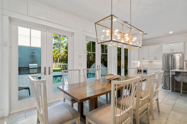 tiled dining room with french doors and a chandelier