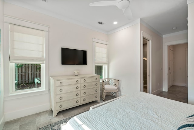 bedroom featuring tile patterned flooring, ceiling fan, multiple windows, and ornamental molding