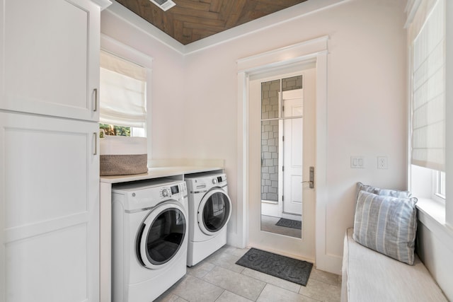 laundry room featuring light tile patterned flooring and separate washer and dryer