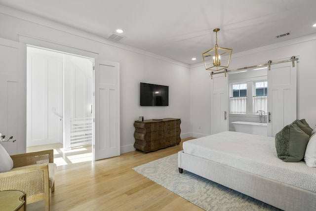 bedroom featuring recessed lighting, light wood-style floors, visible vents, and an inviting chandelier
