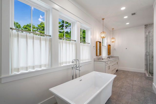 bathroom featuring separate shower and tub, vanity, and tile patterned floors