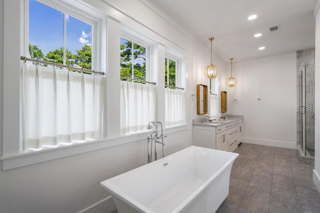 full bathroom featuring vanity, marble finish floor, a freestanding bath, baseboards, and recessed lighting