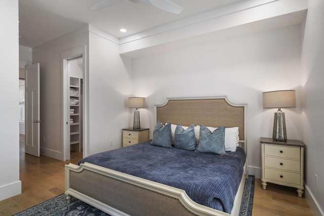 bedroom with baseboards, wood finished floors, recessed lighting, and ceiling fan