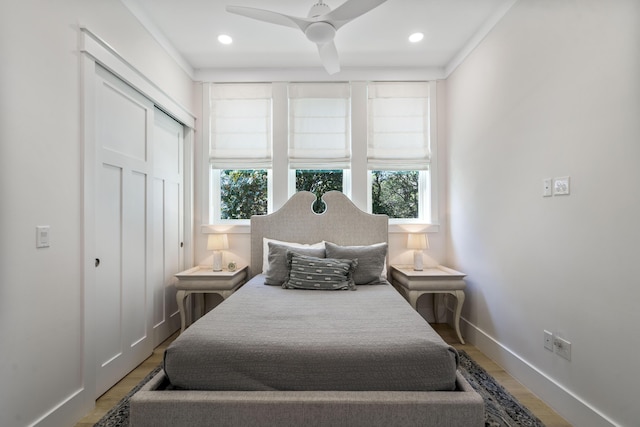 bedroom with a closet, light wood-type flooring, ceiling fan, baseboards, and recessed lighting