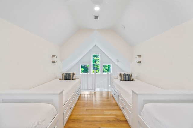 bedroom featuring vaulted ceiling and light hardwood / wood-style floors