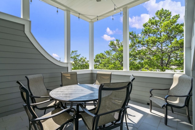 sunroom / solarium with plenty of natural light and outdoor dining space