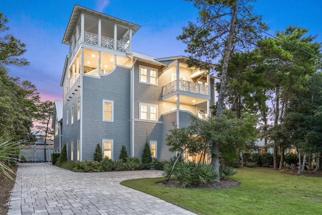 exterior space with a lawn and a balcony