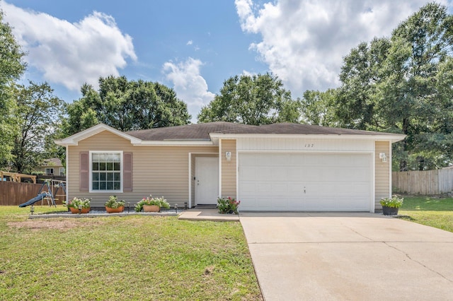 ranch-style home with a front lawn, a playground, and a garage