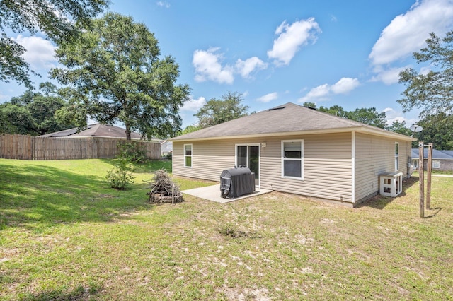 back of property featuring a patio and a yard