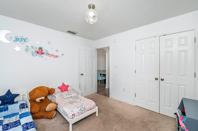 carpeted bedroom with a closet