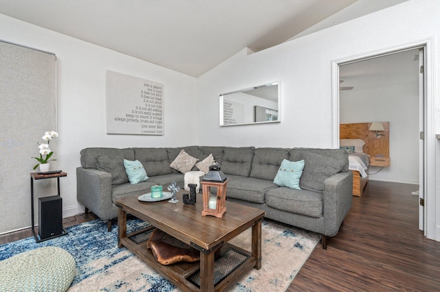 living room featuring vaulted ceiling and dark hardwood / wood-style flooring