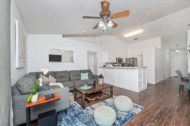 living room featuring ceiling fan, lofted ceiling, and hardwood / wood-style floors