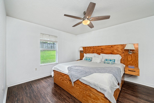 bedroom featuring ceiling fan, a textured ceiling, and dark hardwood / wood-style floors